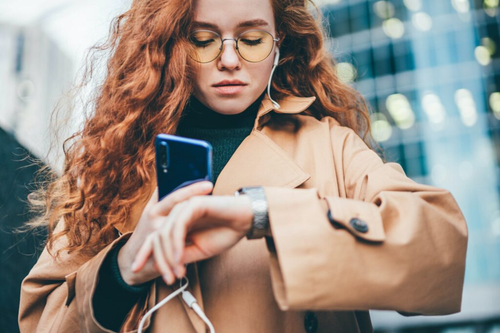 worker young woman wearing fashion clothes waits for business meeting looking at clock